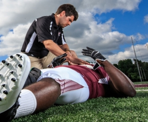 Athletic Trainer Treating Player