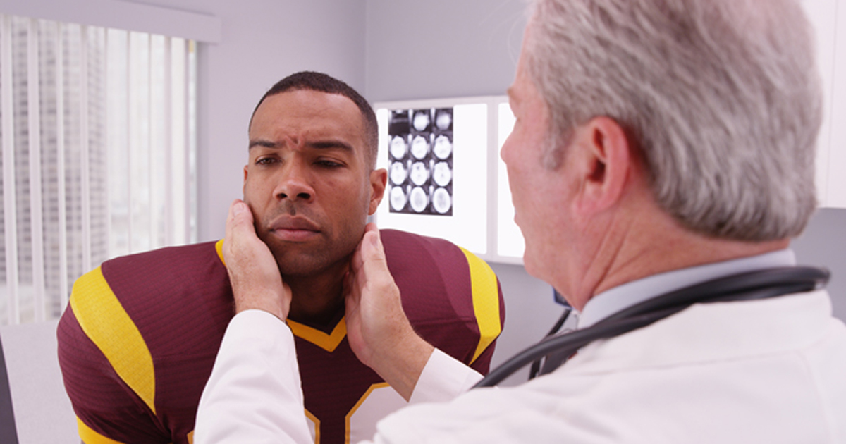 Football player being examined for concussion